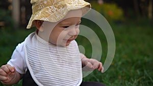 Happy Baby Sitting With Soccer Black White Classic Ball On Green Grass. Adorable Infant Baby Playing Outdoors In