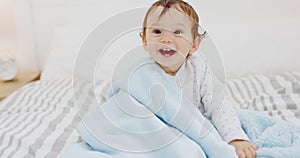 Happy, baby and smile at home on a bedroom bed play and laughing at a house. Portrait of a kid with youth, happiness and