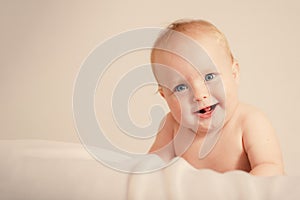 Happy Baby Smile Look Straight Beige Background. toned image