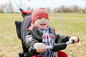 Happy baby on tricycle