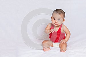 Happy baby wearing red t-shirt.