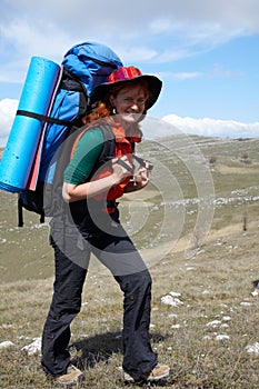 Happy backpacker woman in hat