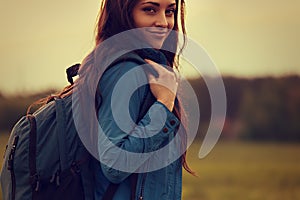 Happy backpacking adventurous woman have a camping trip with blu