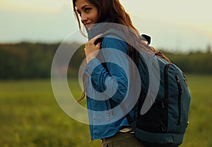 Happy backpacking adventurous woman have a trip with blue huge h