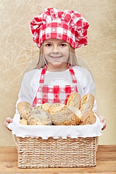 Happy baker holding a basket with fresh products