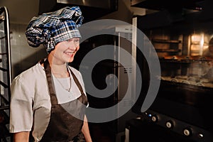 Happy Baker near the stove, smiling