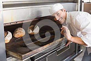 Happy baker by open oven