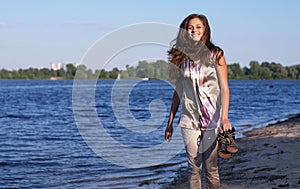 Happy barefoot girl on the beach