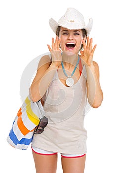 Happy beach woman shouting through megaphone shaped hands