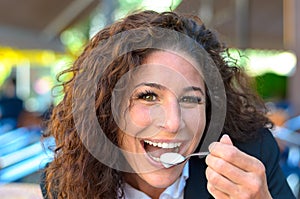 Happy beaming woman eating cream