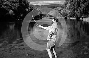 Happy bearded fisher in water. Fishing on the lake at the morning. Gone fishing. Fisherman with rod and fish. Set up rod