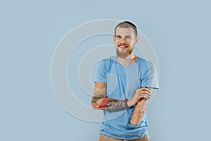 Happy bearded humble man without left hand over blue background