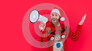 Happy bearded man in Christmas wear shouting in loudspeaker. Christmas Eve announcement