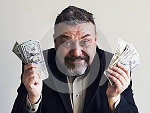 Happy bearded man with dollars in his hands. Success. Finance.