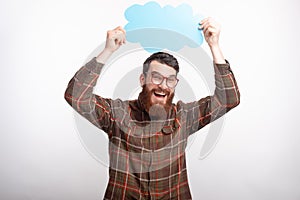 Happy bearded man in glasses holding cloud above his head