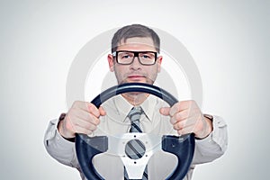 Happy bearded man in glasses with steering wheel, car driver concept