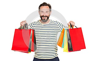 Happy bearded man holding up colorful shopping bags. Christmas and holidays concept. happy and smiled man holding lot of bags