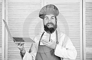 Happy bearded man with laptop. chef recipe. Cuisine culinary. Online shopping. New technology in modern life. food