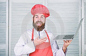 Happy bearded man with laptop. chef recipe. Cuisine culinary. Online shopping. New technology in modern life. food