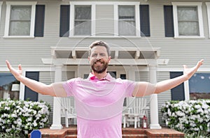 happy bearded man owner near new house after rent or buy new home, ownership