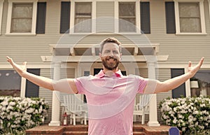 happy bearded man owner near new house after rent or buy new home, ownership