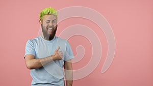 Happy bearded man pointing finger away, showing freespace for advertisement