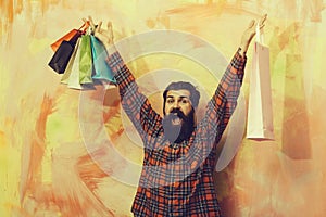 Happy bearded man shouting with colorful paper shopping bags