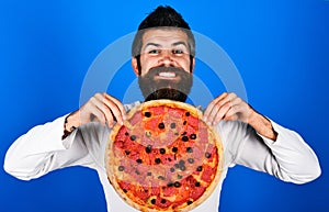Happy bearded man with tasty pepperoni pizza. Fastfood. Pizzeria advertising. Food delivery.