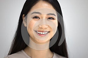 Happy beautiful 20s Asian woman facial close up portrait