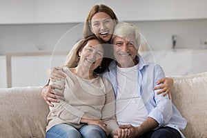 Happy beautiful adult daughter woman hugging elder mom