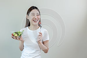 Happy beautiful asian female body slim eating salad vegetables. weight loss diet and healthy food. copy space