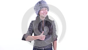 Happy beautiful Asian woman giving thumbs up