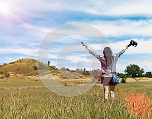 Happy Beautiful Asian Woman with Hat and Bag Ready to Start Vacation at The Corner with Scenery Mountain in Background