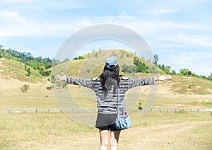 Happy Beautiful Asian Woman with Hat and Bag Ready to Start Vacation with Scenery Mountain in Background