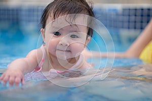 happy and beautiful Asian woman holding her little baby girl playful - Korean mother and adorable daughter playing on water at