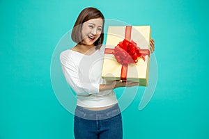 Happy beautiful asian woman smile with gold gift box isolated on green background.