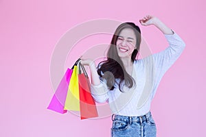 Happy beautiful Asian women enjoy shopping on pink background, Shopaholic, Buy during promotion or special offer price in