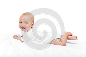 Happy beautiful baby girl in white body suit