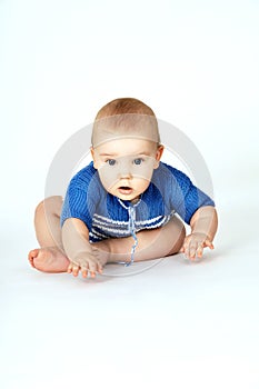 Happy beautiful baby sitting on the floor