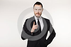 Happy beautiful bearded guy with good-looking hairstyle, wearing black suit and tie