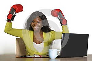 Happy beautiful black afro American woman in boxing gloves smiling cheerful working at office computer desk posing as successful e