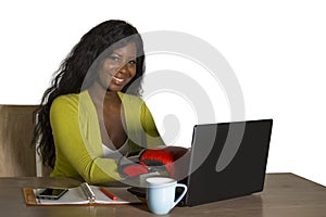 Happy beautiful black afro American woman in boxing gloves smiling cheerful working at office computer desk posing as successful e