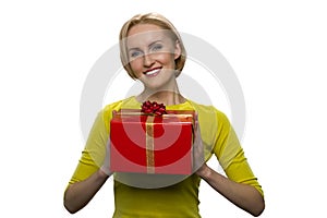 Happy beautiful blonde woman with big red gift box isolated on white background.