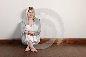 Happy beautiful blonde woman in knitted cardigan photo