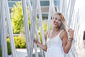 Happy beautiful blonde woman smiling looking at the camera and p