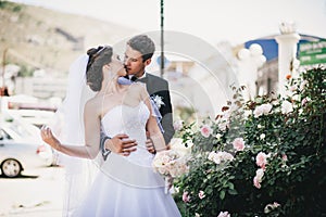 Happy and beautiful bride and groom kissing