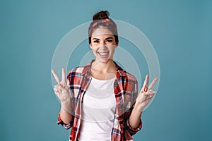 Happy beautiful brunette girl smiling and gesturing peace sign