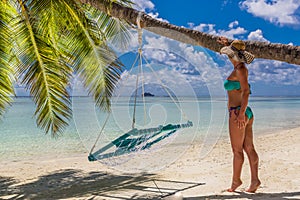 Happy beautiful carefree woman enjoying sunshine on the beach. Young woman in red pink bikini in white sandy beach at Maldive