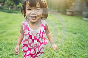 Happy beautiful child`s expression at home backyard