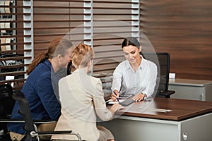 Happy beautiful couple is buying a new car at dealership. Family council